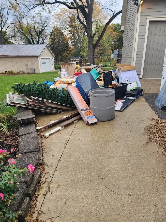 Dumpster being loaded with debris for 12 Yard Dumpster Rental in Magnolia